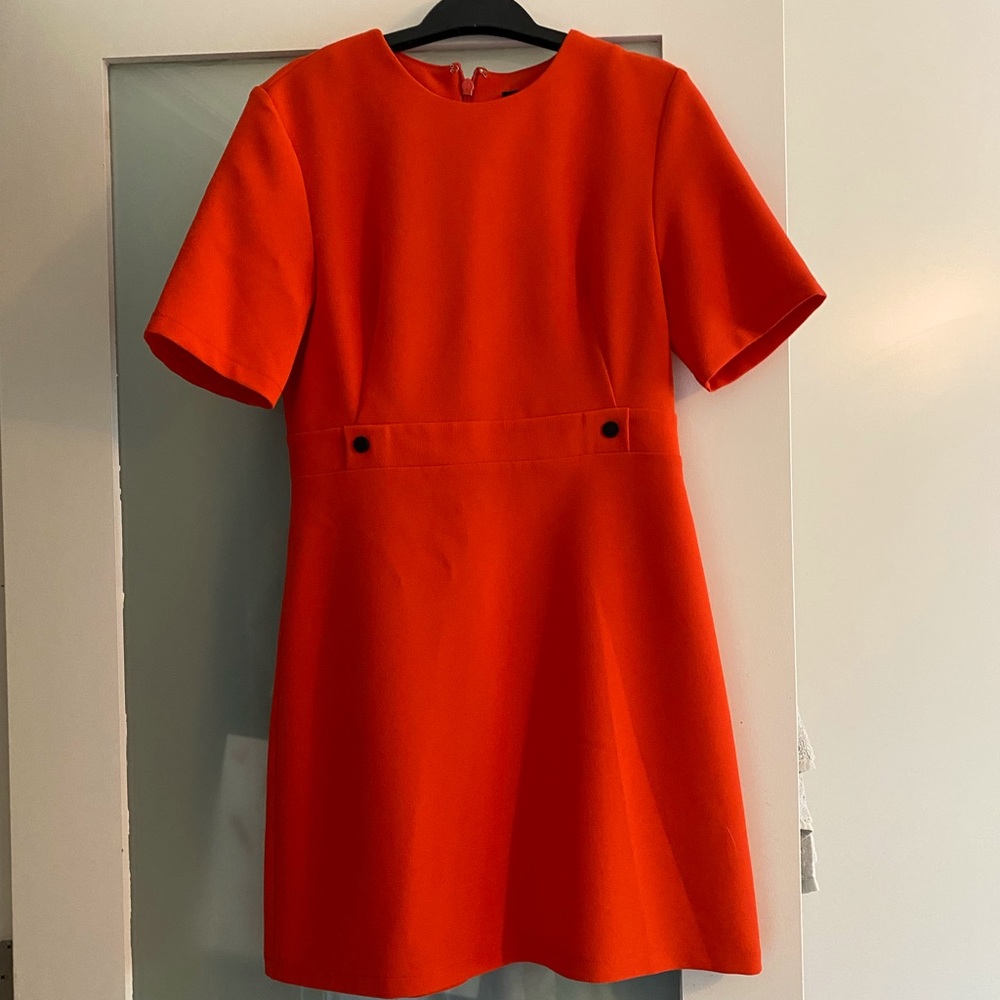 Orange mini dress, very mod. Maybe a little sexy flight attendant. Fits small.